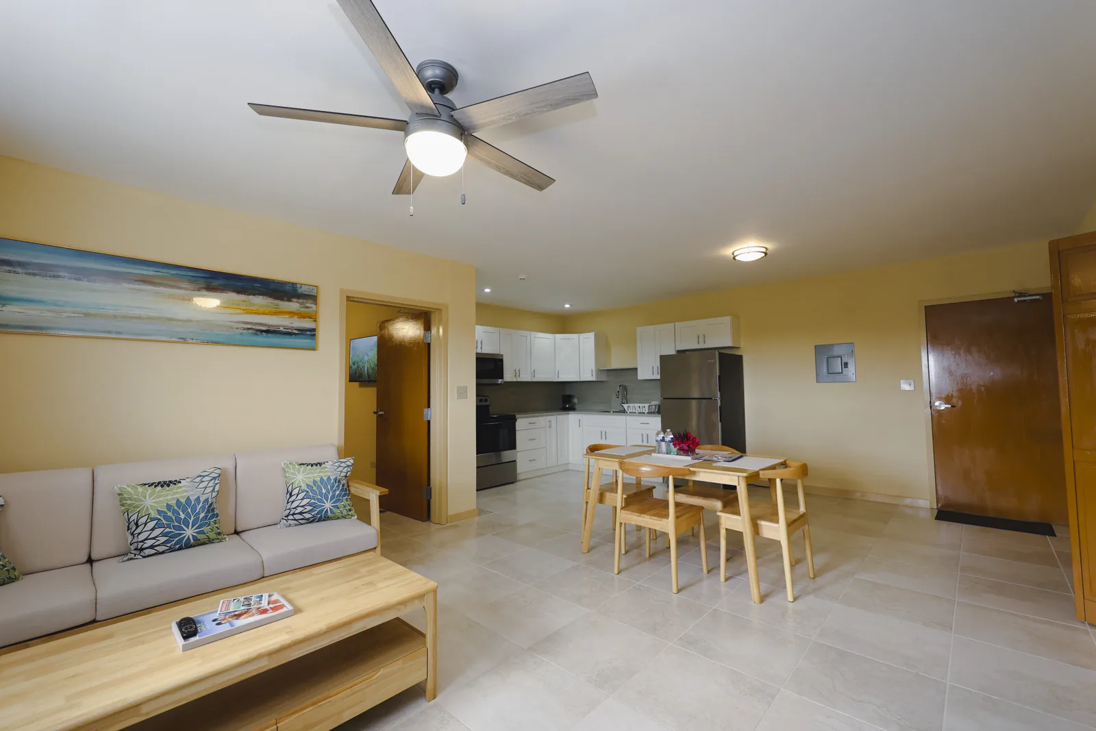 Bright furnished Santa Cruz Suites living and dining area with a kitchen